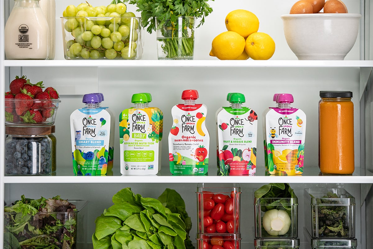 fridge filled with once upon a farm pouches and fresh produce