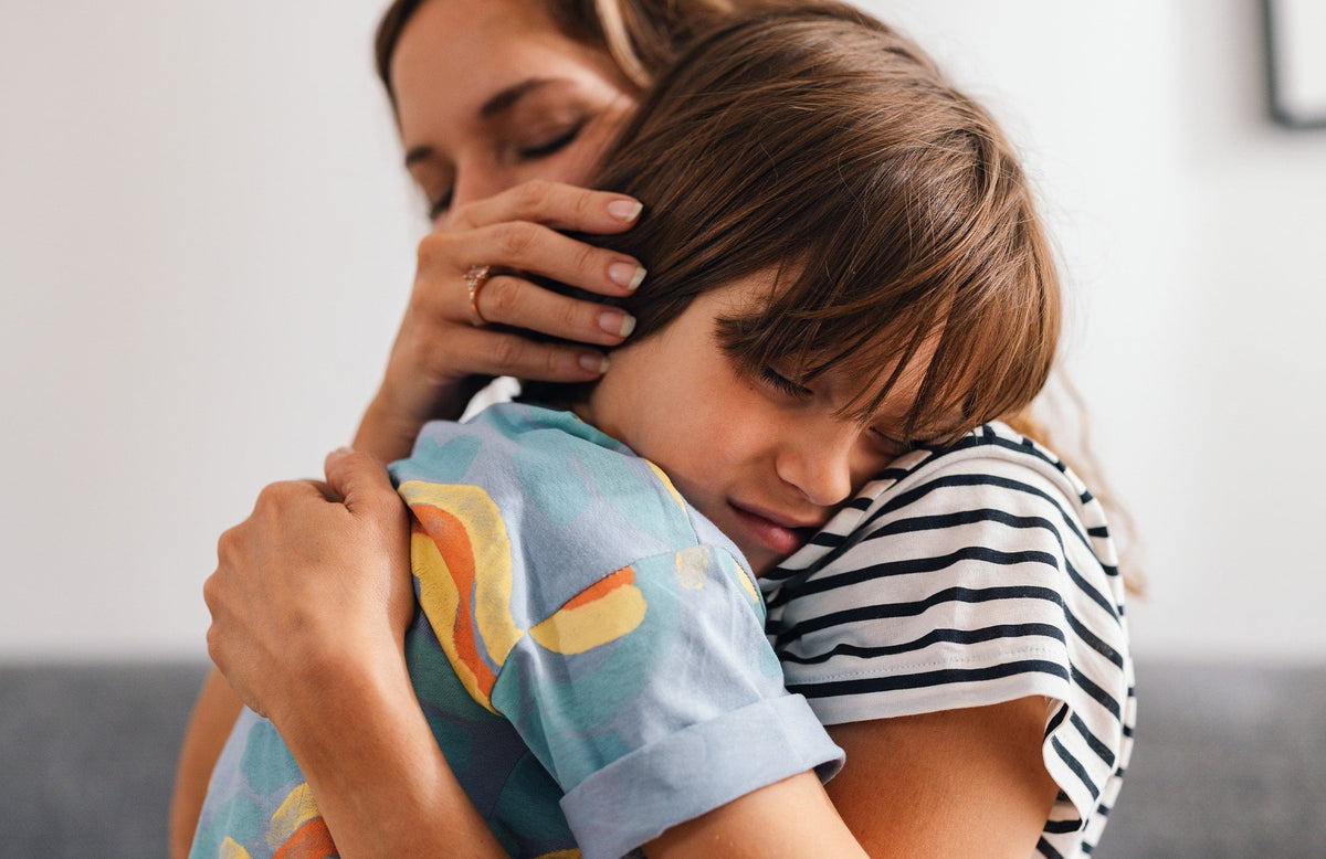 mother hugging and comforting son