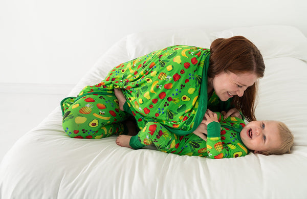 Mom and baby in matching Once Upon a Farm x Little Sleepies pajamas