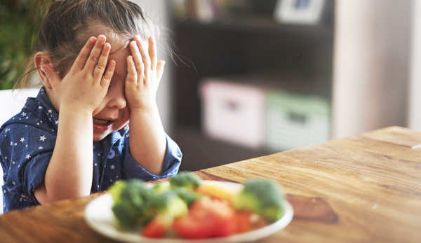 Picky eater crying over food.