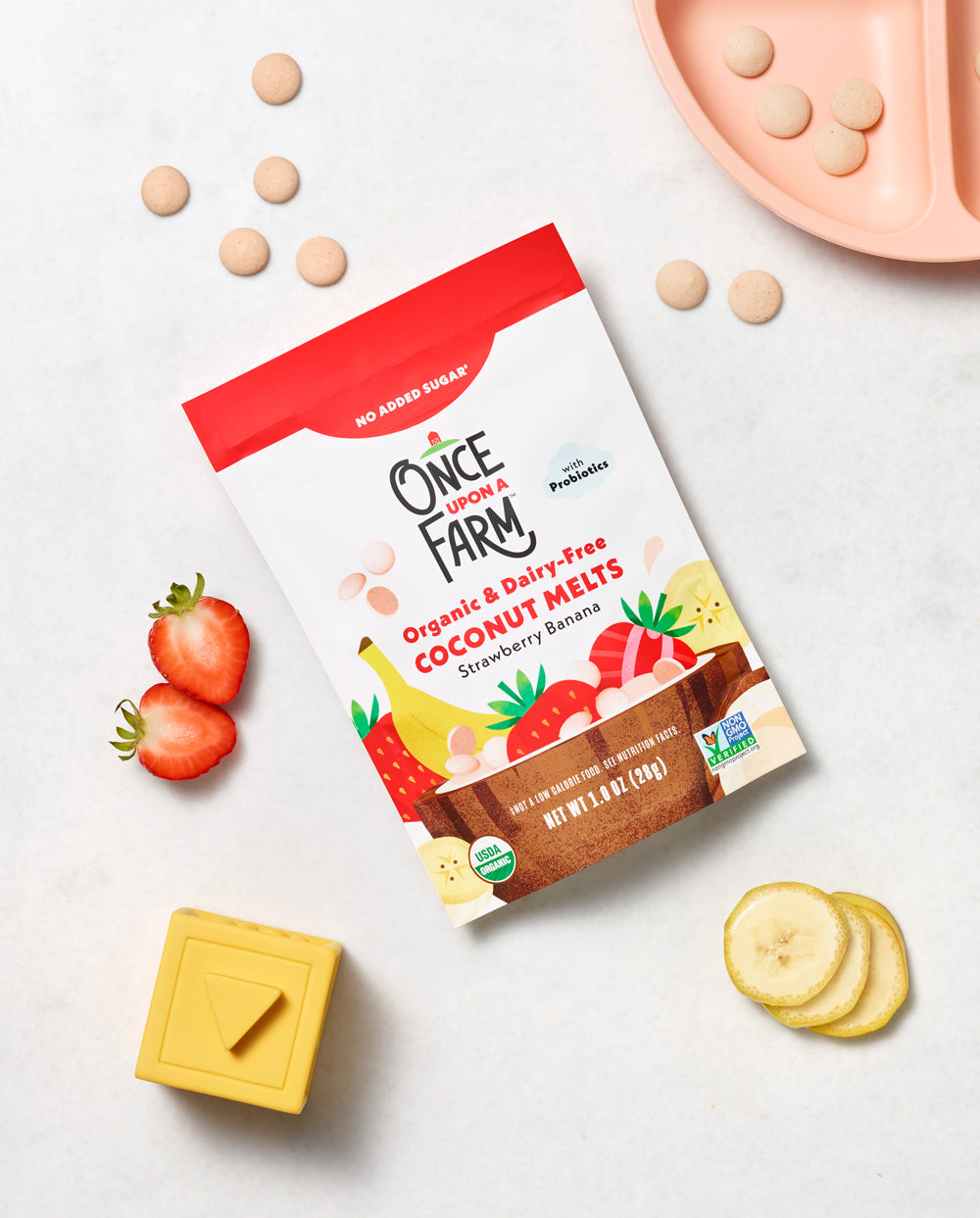 Strawberry Banana Coconut Melts on a table with Strawberries and Banana.