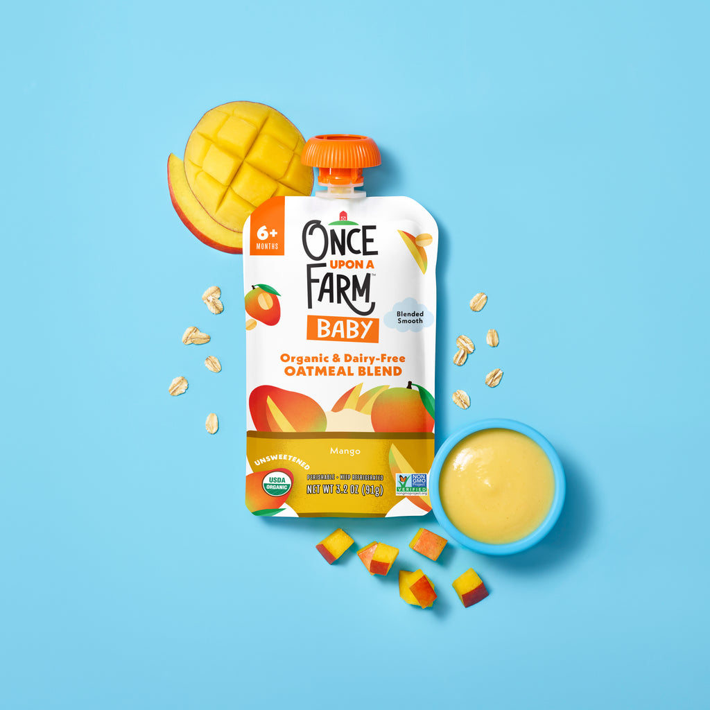 Once Upon A Farm Mango Baby Oatmeal Blend with real mangos and oats on a blue background